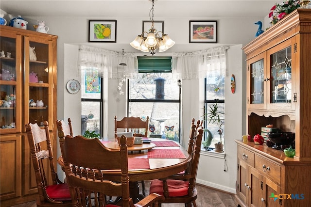 dining area with a notable chandelier and hardwood / wood-style floors