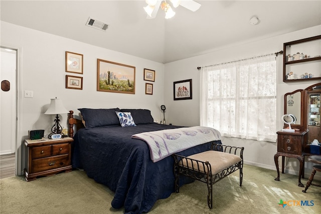 carpeted bedroom with vaulted ceiling and ceiling fan