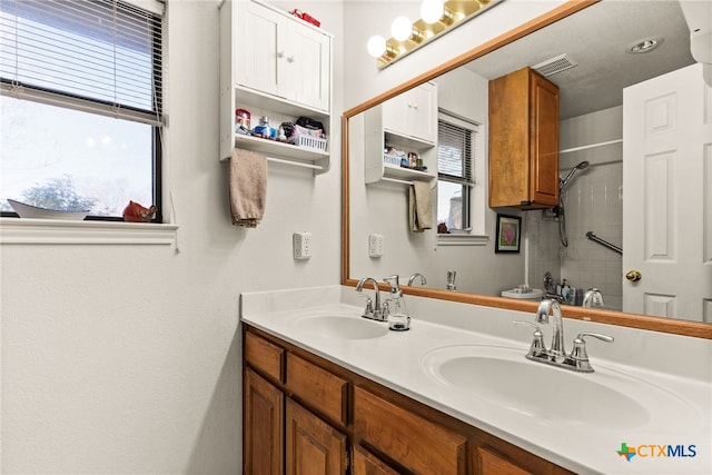 bathroom featuring vanity and a shower