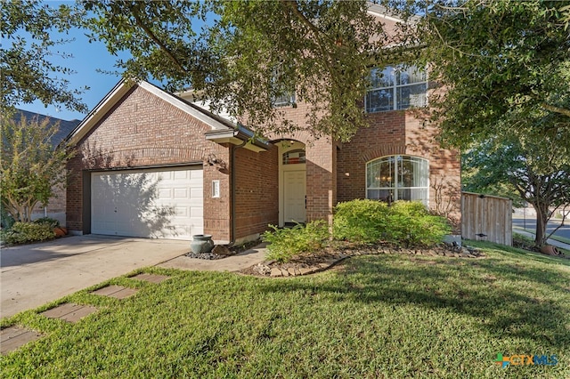 view of front of property with a garage and a front lawn