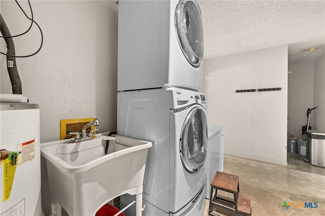 501 Geri Dr, Copperas Cove, TX 76522 - laundry room featuring stacked washer and clothes dryer, electric water heater, and a textured ceiling