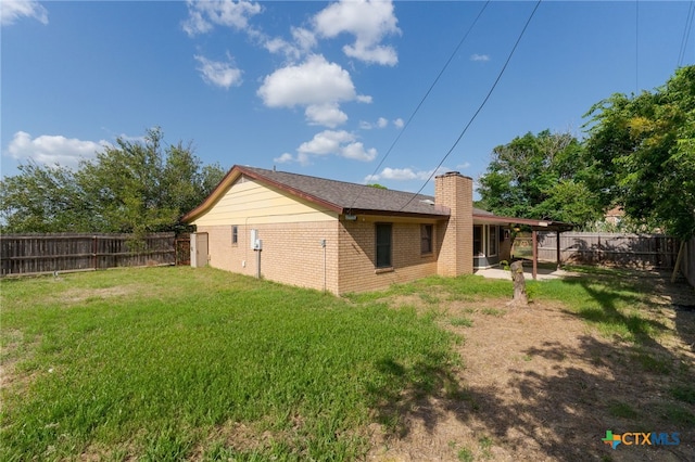 501 Geri Dr, Copperas Cove, TX 76522 - back of property with a fenced backyard, brick siding, and a chimney