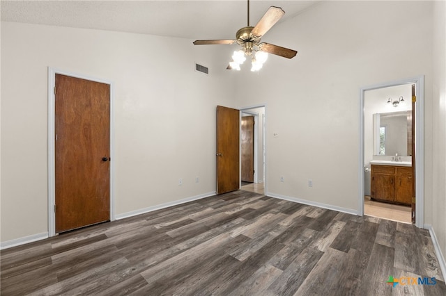 501 Geri Dr, Copperas Cove, TX 76522 - unfurnished bedroom featuring high vaulted ceiling, dark wood-style floors, ensuite bathroom, and a ceiling fan