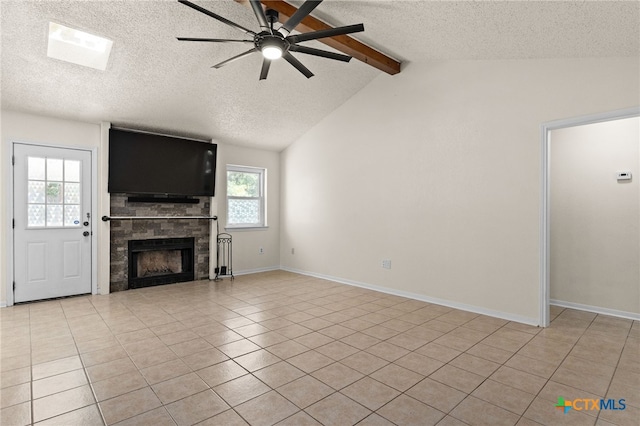 501 Geri Dr, Copperas Cove, TX 76522 - unfurnished living room with a textured ceiling, a ceiling fan, a tile fireplace, and light tile patterned flooring