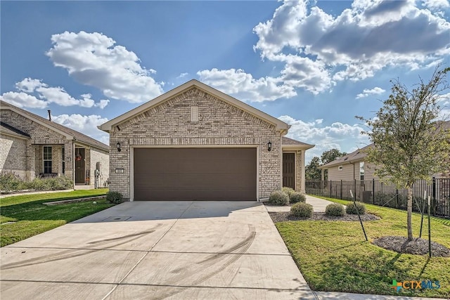 view of front of home featuring a garage and a front yard