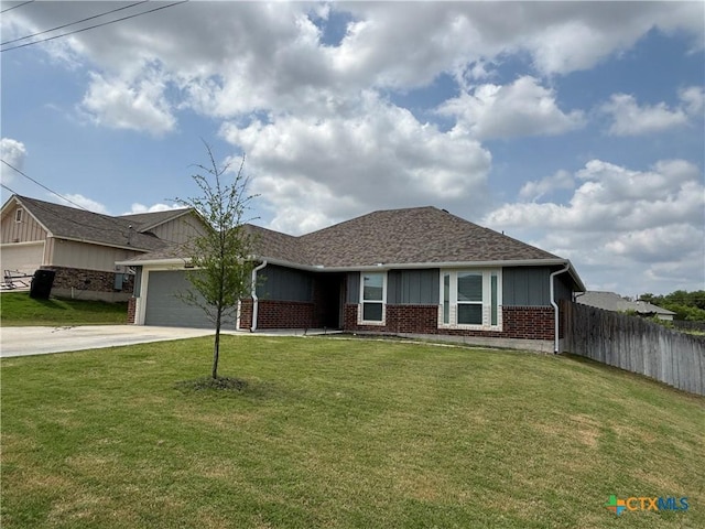 ranch-style home with fence, brick siding, a garage, a front yard, and driveway