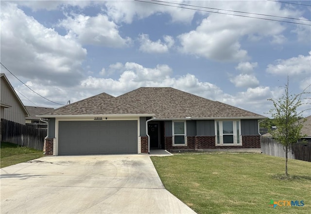 ranch-style house featuring a garage, fence, a front yard, brick siding, and driveway