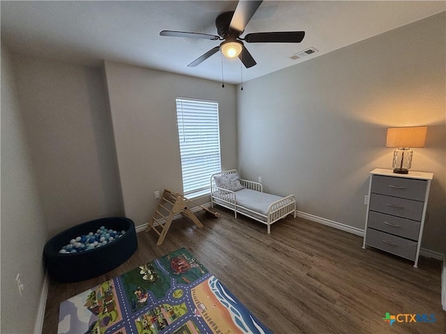 bedroom featuring baseboards, ceiling fan, dark wood finished floors, and visible vents
