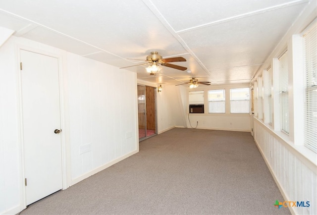 unfurnished sunroom featuring ceiling fan