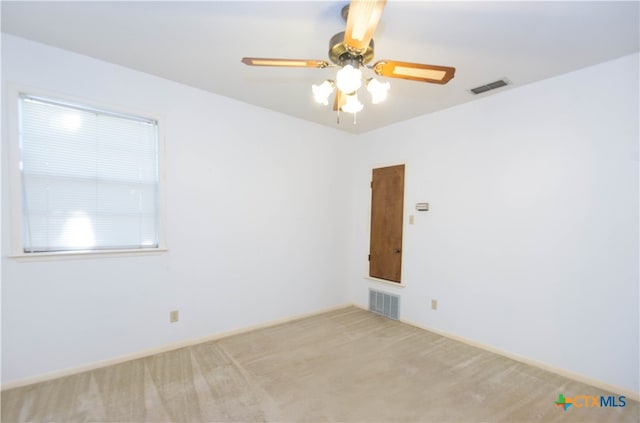 empty room featuring light carpet and ceiling fan