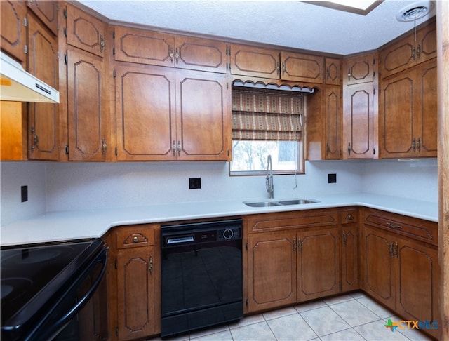 kitchen with light tile patterned floors, sink, a textured ceiling, and black appliances