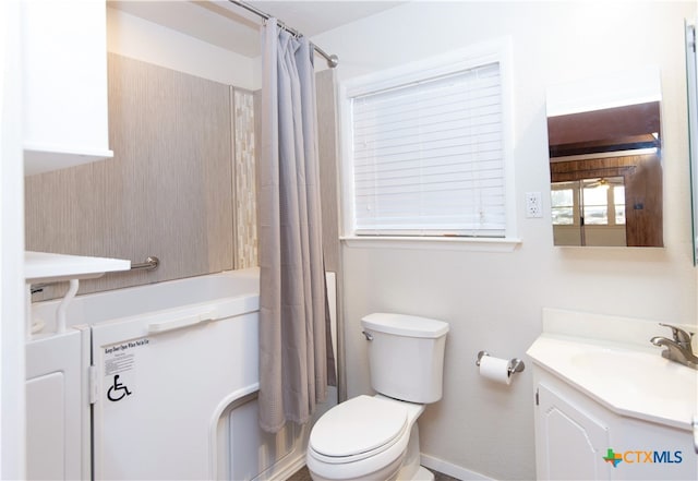 full bathroom featuring shower / bath combo, vanity, and toilet