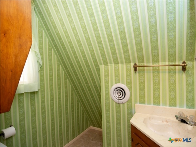 bathroom with vanity and vaulted ceiling