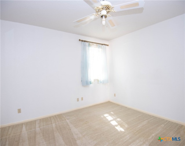 carpeted spare room with ceiling fan