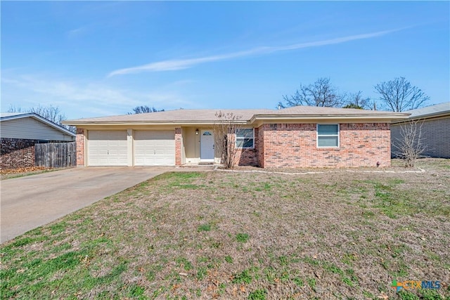 ranch-style house featuring concrete driveway, an attached garage, fence, and a front yard