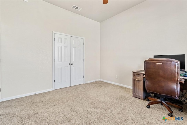 carpeted office space featuring ceiling fan and vaulted ceiling