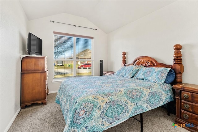 bedroom with light colored carpet and lofted ceiling