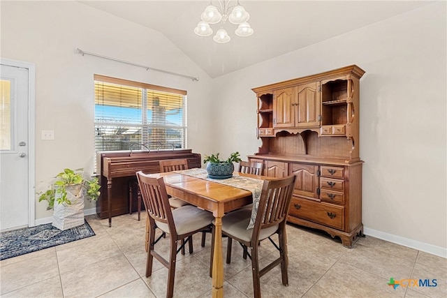 tiled dining area featuring lofted ceiling and a chandelier