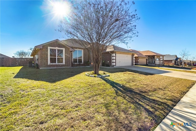 ranch-style home with a front yard and a garage