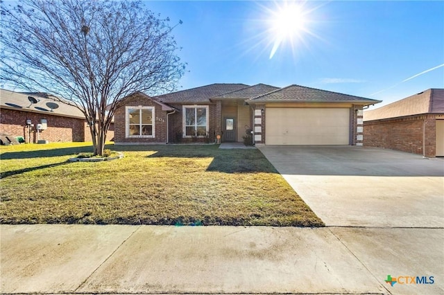 view of front of property with a garage and a front lawn