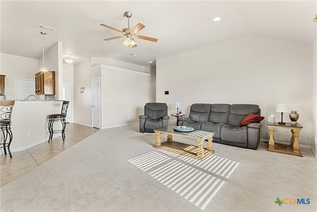 tiled living room with ceiling fan and lofted ceiling