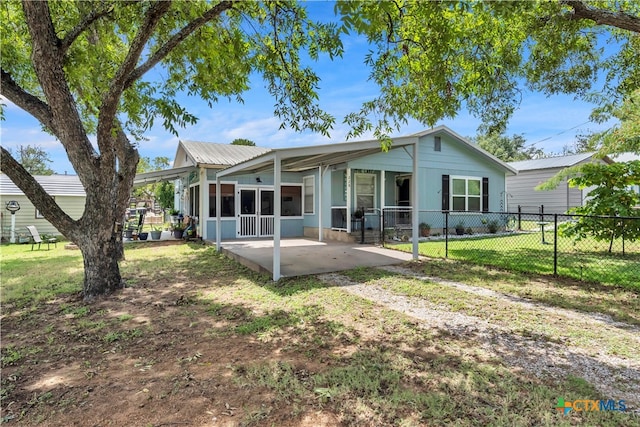 rear view of house featuring a yard