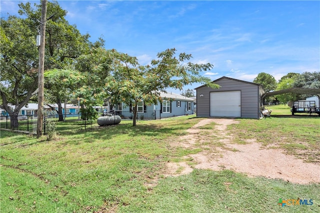 view of front of property featuring an outbuilding, a garage, and a front yard