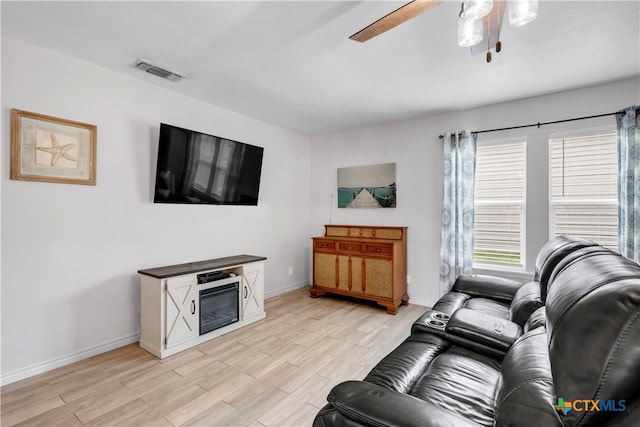 living room with ceiling fan and light wood-type flooring