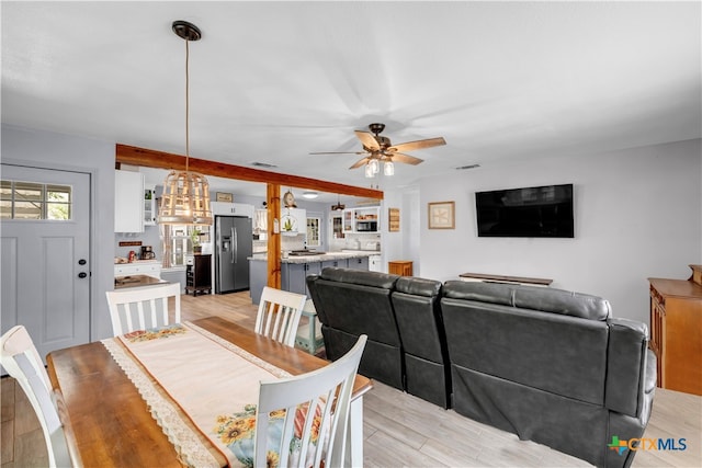 dining area with light wood-type flooring and ceiling fan