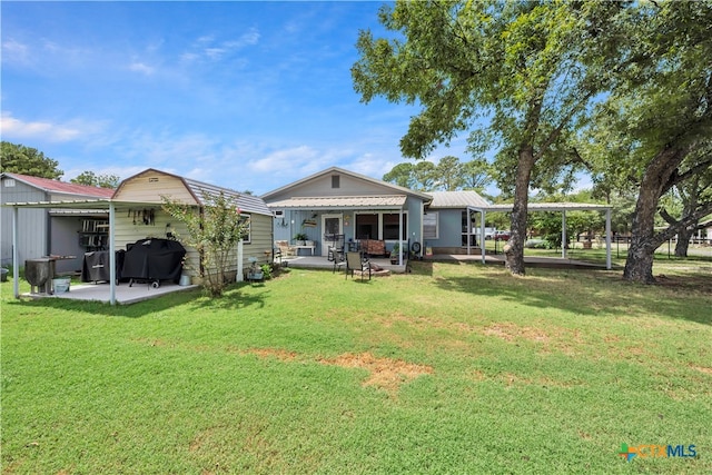 rear view of house featuring a lawn and a patio area