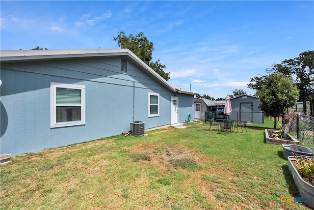 exterior space featuring central air condition unit and a yard