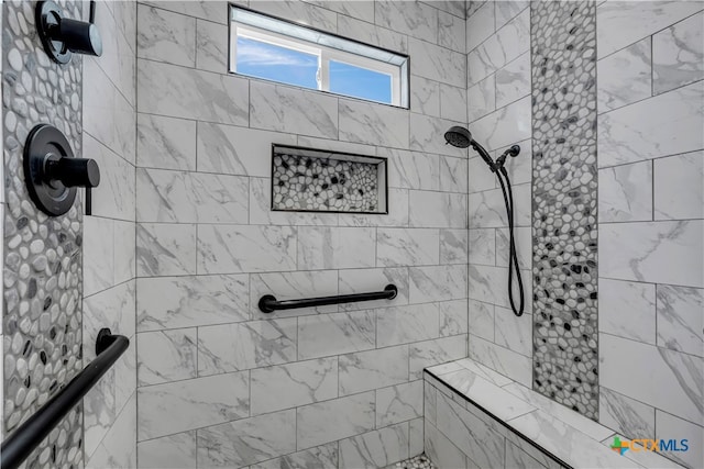 bathroom with tiled shower