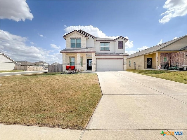 front of property featuring a front yard and a garage