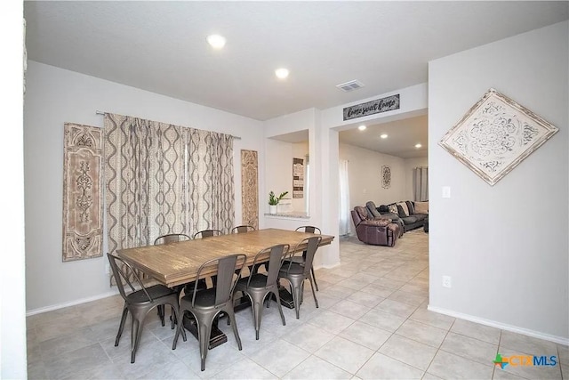 dining space featuring light tile patterned flooring