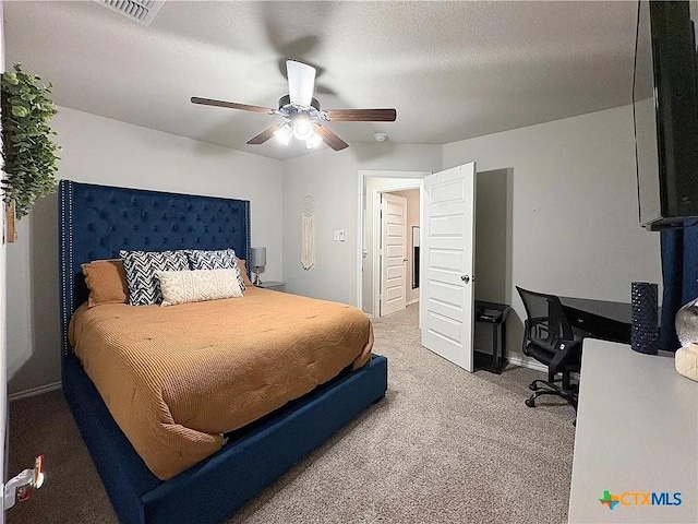 bedroom featuring carpet, a textured ceiling, and ceiling fan