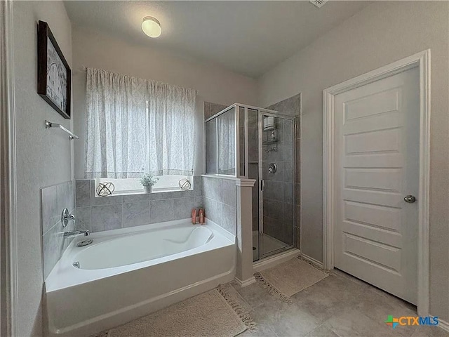 bathroom with independent shower and bath and tile patterned floors