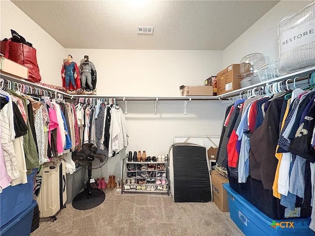 walk in closet featuring carpet