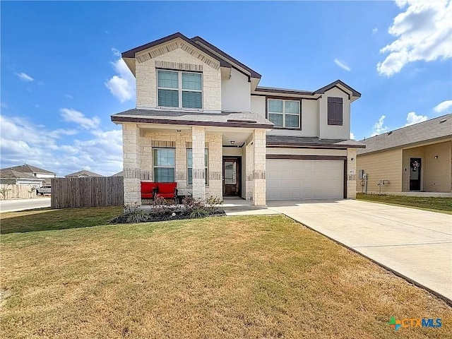 view of front of home featuring a front yard and a garage