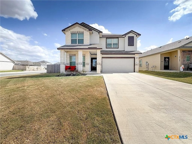 view of front of home with a front yard and a garage