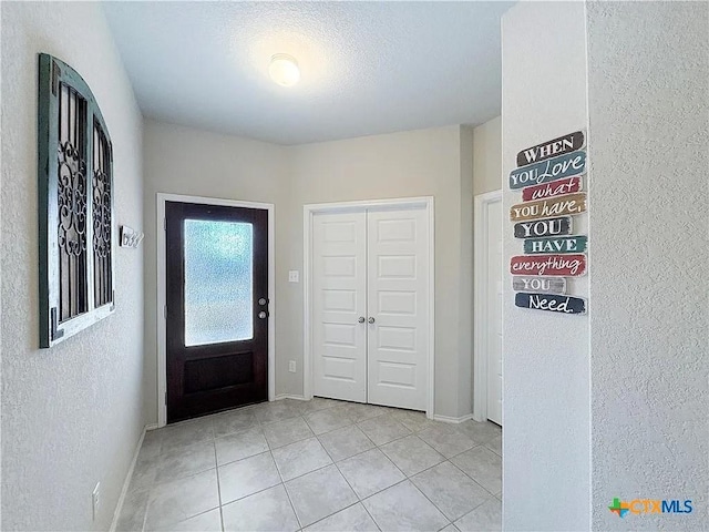 foyer entrance featuring light tile patterned floors