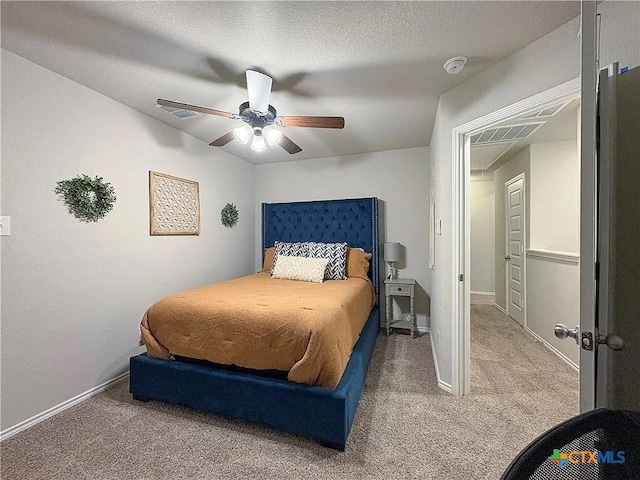 carpeted bedroom featuring ceiling fan and a textured ceiling