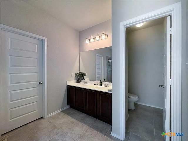 bathroom featuring tile patterned floors, toilet, and vanity