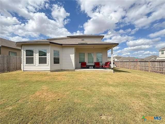 back of house featuring a patio and a yard