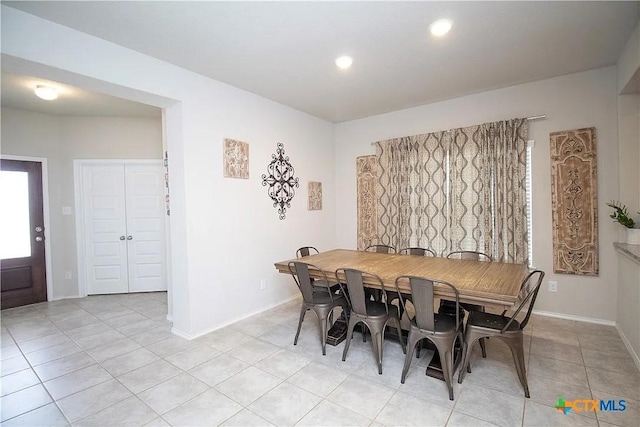 dining area with light tile patterned flooring