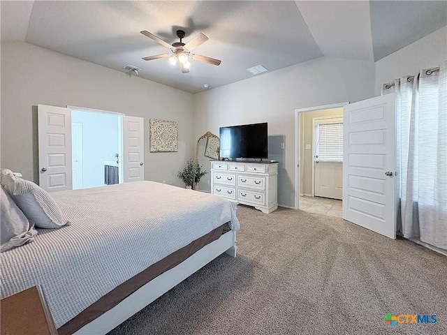 carpeted bedroom featuring vaulted ceiling and ceiling fan