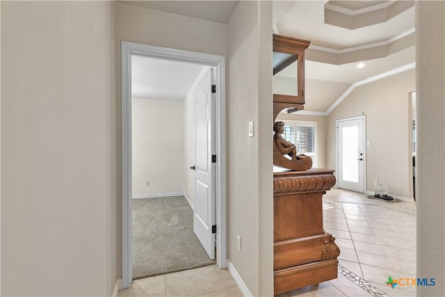 corridor featuring light colored carpet, crown molding, and vaulted ceiling