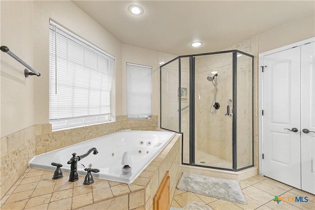 bathroom with separate shower and tub and tile patterned flooring