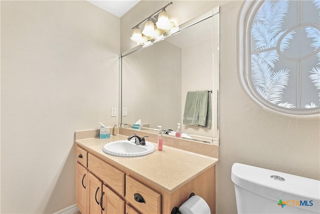 bathroom featuring toilet and vanity