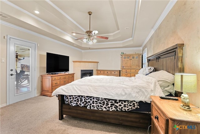 bedroom featuring ceiling fan, access to outside, a raised ceiling, ornamental molding, and light carpet