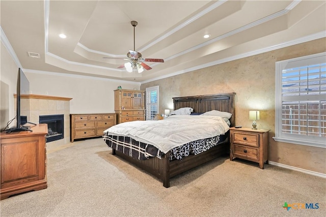 bedroom featuring a raised ceiling, light colored carpet, ceiling fan, and crown molding